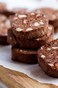 some brownies are sitting on a cutting board and have been cut into small pieces