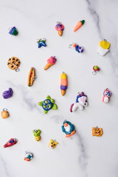 many different colored toy animals on a marble surface