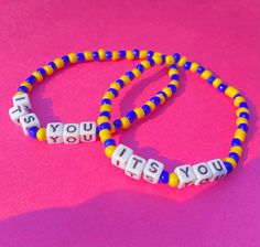 two beaded bracelets that say, you're it's you