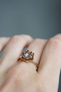 a woman's hand with a gold ring on it