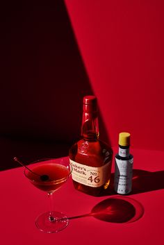 a bottle of alcohol next to a glass with a spoon