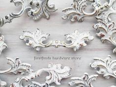 several white ornate designs on a wooden surface with the words fresh finds hardware store above them