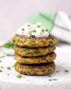 there is a stack of food on top of a plate with sour cream and chives