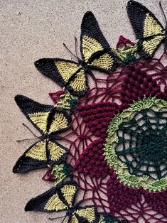 a crocheted doily with butterflies on it