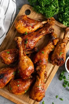 chicken wings on a cutting board with ketchup and parsley