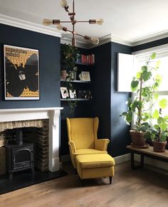 a living room filled with furniture and a fire place in front of a painting on the wall