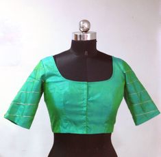 Blue green pure raw silk blouse with geometric hand embroidery on the sleeves. Custom fitted. -Measurements sheet will be sent to you once you order( Standard sizing also available) -Custom colors available -Work on front back and sleeves. Please convo me if you're have any specific requirements. This blouse can be done with or without the bust cup inserts . The blouse is fully lined is cotton. Usual turn around time is 1-2 weeks, but we may be able to accomodate emergency requests if possible. Fitted Green Raw Silk Choli, Elegant Green Chanderi Blouse, Fitted Green Tops With Resham Embroidery, Fitted Cotton Silk Designer Tops, Designer Green Cotton Silk Blouse, Green Cotton Silk Blouse For Designer Wear, Fitted Cotton Silk Blouse For Designer Wear, Elegant Fitted Chanderi Top, Silk Green Blouse With Resham Embroidery