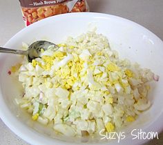 a white bowl filled with food next to a bag of cereal