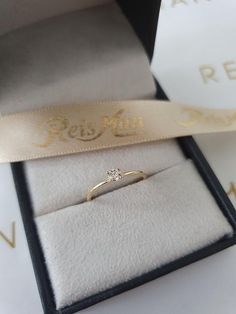 an engagement ring sits in its presentation box