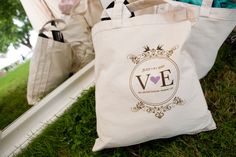 a white bag sitting on top of a green grass covered ground next to other bags