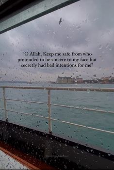 rain drops on the window of a boat as it travels down the ocean with a quote written below