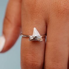 Sink your teeth into the Stone Shark Tooth Ring, designed in partnership with Discovery’s Shark Week. This limited-edition style is set on a delicate silver band, with an enamel shark tooth charm for the ocean-obsessed. For each Shark Week style sold, 5% of the purchase price* will be donated to Oceana, Inc. to help save sharks and protect the oceans, with a minimum donation of $50,000 by April 30th, 2023. - Brass base with rhodium plating & enamel- Shark tooth: 10mm (H) x 10mm (W)- Because jewe Shark Clothes, Shark Tooth Ring, Shark Ring, Shark Teeth Jewelry, Kite Accessories, Shark Jewelry, Flower Spinner, Tooth Ring, Tooth Charm