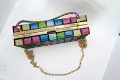 This versatile bag is a clutch, purse and over the shoulder. Its hard exterior makes it durable and is cover in colorful rhinestones. This is definitely a statement piece. Its Hard, Clutch Purse, Statement Pieces, Purse, Exterior, Color