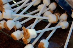 several marshmallows are arranged on a glass plate with toothpicks in them