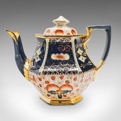 an ornately decorated tea pot with gold trimming