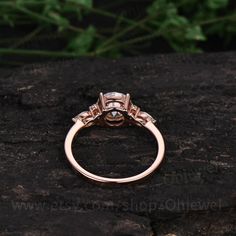 an engagement ring on top of a rock