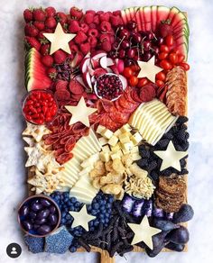 a platter filled with fruits and vegetables on top of a table