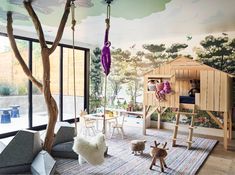 a child's room decorated in wood and painted with trees, animals, and other things