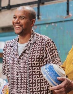 a man holding a plastic cup and smiling