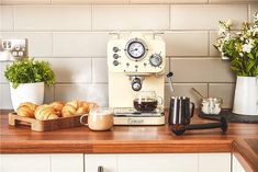 an espresso machine sitting on top of a wooden counter