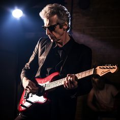 a man playing an electric guitar on stage