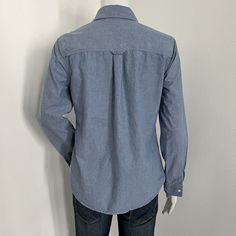 J. McLaughlinUS Women's Size XSBlue chambray button up collared top with long sleeves. Good condition. Please see pictures for details.MeasurementsShoulder | 15 inches seam to seam straight across back of the shirtSleeve | 25 inches center back of the shirt to the end of the cuffLength | 24 inches center base of the back of the collar to the end of the shirtChest Circumference | 18 inches x 2 = 36Please note that color may vary a small amount because of my lighting. If you have questions please ask and I would be happy to help! -Michelle Casual Slim Fit Blouse With Spread Collar, Denim Blue Collared Workwear Blouse, Collared Denim Blue Blouse For Work, Denim Blue Button-up Workwear Blouse, Denim Blue Collared Blouse For Work, Casual Long Sleeve Shirt With Back Button Closure, Casual Slim Fit Button-up Blouse, Collared Denim Blue Cotton Blouse, Denim Blue Long Sleeve Blouse With Button Closure