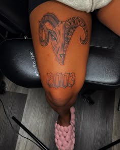 a woman's legs with tattoos on them and the word boo spelled in cursive writing