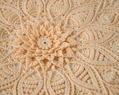 an intricate crochet design is shown on the surface in this close up photo