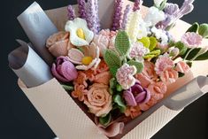 a bouquet of crocheted flowers in a box