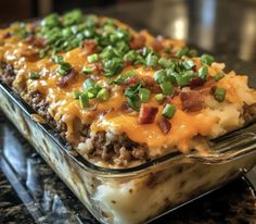 a casserole dish with meat, cheese and green onions