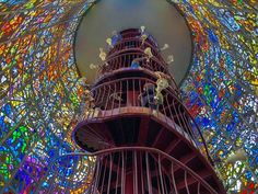 a tall tower with lots of stained glass windows