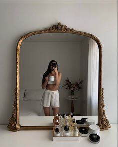 a woman taking a selfie in front of a mirror