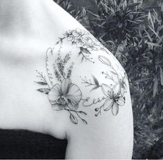 a woman's shoulder with flowers on it