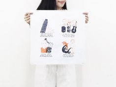 a woman holding up a poster with different things on it