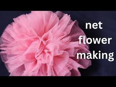 a pink flower sitting on top of a black surface with the words net flower making above it