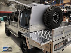 a silver truck parked inside of a garage