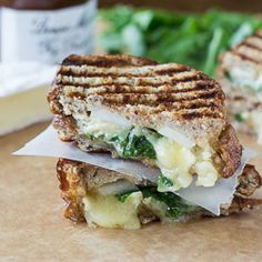 a grilled cheese and spinach sandwich cut in half