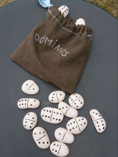 some white rocks sitting on top of a table next to a drawsack and bag