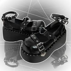 Step into a world of enchanting style with these platform Mary Jane shoes. Designed with a bold and unique aesthetic, these shoes feature an ankle strap adorned with striking stud decorations, adding an edgy touch to your outfit. The upper part showcases a captivating devil wing design, intricately connected by a charming heart-shaped ring, making a statement wherever you go. The toe area is elegantly finished with a heart-decorated buckle strap, adding a sweet yet rebellious flair. Perfect for Punk Heels With Platform And Round Toe, Punk Style Platform Heels With Round Toe, Punk Style Round Toe Heels With Platform, Platform Heels With Round Toe For Concerts, Punk Chunky Platform Heels With Ankle Strap, Punk Ankle Strap Platform Heels, Edgy Platform Heels With Ankle Strap, Edgy Platform Heels For Alternative Fashion, Punk Ankle-high Platform Heels