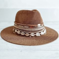 "This hat will just look so stylish with everything! Great for Festivals, beach, a day out and about A packable, knit Panama hat is perfect for your next tropical vacation! Wear it daytime to night time, with a bathing suit or a cute outfit.   Choose your initial, your name beaded on the hat, or just opt for rows of jewelry and trim.    One size fits most  Dented crown - Straw construction - Flat brim  Approx. 3\" brim/band height, 4.5\" crown height - Approx. 22.4\" inner circumference   Import Beachy Toquilla Straw Bucket Hat, Adjustable Toquilla Straw Fedora For Beach, Adjustable Straw Boater Hat For Beach Season, Adjustable Coastal Fedora For Beach, Flat Brim Toquilla Straw Sun Hat For Festival, Bohemian Toquilla Straw Bucket Hat With Short Brim, Toquilla Straw Bucket Hat For Beach Season, Bohemian Bucket Hat With Curved Brim In Toquilla Straw, Bohemian Straw Boater Hat With Flat Brim