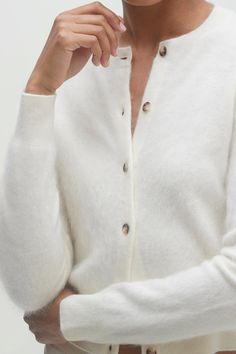 Introducing our cozy yet chic Paloma Cardigan – your new go-to for comfort with a touch of sophistication. This cardigan is all about the plush feel of brushed cashmere, offering a luxurious experience every time you slip it on. 230 grams of 100% brushed cashmere in 12-gauge knit Hand Finished Cropped cardigan Crewneck Button-front closure Ribbed trim 19 5/8" length (size XS/S) Dry Clean Only White Cashmere Cardigan With Button Closure, Cozy White Cashmere Cardigan, Ecru Color, Genetically Modified, 12 Gauge, Summer Blue, Cashmere Cardigan, Cropped Cardigan, Mens Outerwear