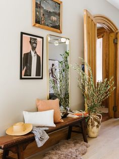 a wooden bench sitting in front of a mirror