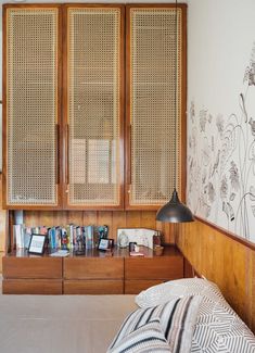 a bedroom with wooden furniture and wallpaper