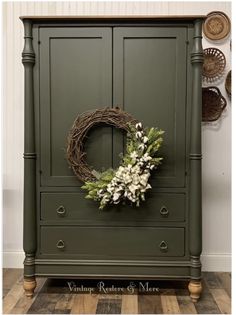 a green armoire with a wreath on it