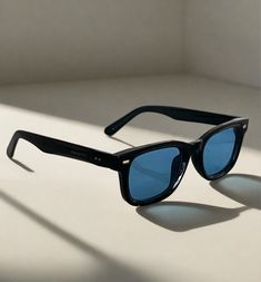 Expertly designed with a classic wayfarer style, the Icon sunglasses offer 100% UV protection with its black acetate frame and blue lenses. The square frame gives a sleek and modern look, making them perfect for any occasion. Add a touch of sophistication to your wardrobe with the Icon style sunglasses. Unisex. Icon Style, Blue Lens, Style Sunglasses, Blue Lenses, The Square, Square Frame, Square Frames, Bag Straps, Fashion Sunglasses