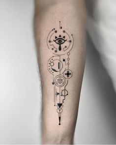 a black and white tattoo design on the right arm, with an eye in the center