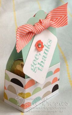 an open gift box with a bow on the top and tag hanging from it's side