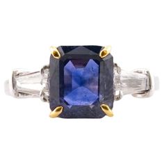 This exquisite piece is a testament to the timeless artistry of Antinori di Sanpietro. Crafted in Italy, the ring boasts a majestic sapphire, weighing 4.23 carats, at its center. The sapphire, a gem of arresting blue, is certified by the GRS, ensuring its authenticity and quality. According to the GRS report, the sapphire is unheated and untreated, making it a rare and authentic gemstone that radiates a natural, intense blue. Flanking the sapphire are two tapered baguette diamonds, meticulously Luxury Gia Certified Platinum Gemstones, Luxury Cushion Cut Sapphire Ring With Vvs Clarity, Luxury Gia Certified Cushion Cut Sapphire Ring, Elegant Yellow Gold Gemstones With Center Stone, Luxury Sapphire Ring With Brilliant And Baguette Cuts, Luxury Sapphire Gemstones With Vvs Clarity, Formal Gia Certified Emerald Cut Sapphire Ring, Gia Certified Emerald Cut Sapphire Ring For Formal Occasions, Fine Jewelry Platinum Gemstones For Formal Occasions