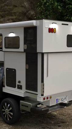 a white truck parked next to a tree