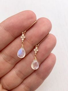 Rainbow Moonstone Earrings, Teardrop Dangle Earrings, Minimalist Gold Earrings, June Birthstone, Small Moonstone Earrings, Gift for women These precious delicate earrings feature blue flash rainbow moonstone teardrops adorned with a white topaz connector in either gold filled or sterling silver. The earrings are suspended from lever back ear wires in the finish of your choice. These earrings are very feminine and subtle, perfect for every day and the moonstone makes them suitable for almost any Elegant Moonstone Dangle Crystal Earrings, Moonstone Crystal Dangle Earrings, Moonstone Drop Earrings With Ear Wire, Delicate Dangle Moonstone Earrings, Minimalist Moonstone Jewelry With Ear Wire, Delicate Dangle Moonstone Jewelry, Delicate Teardrop Moonstone Earrings, Delicate Moonstone Dangle Jewelry, Dainty Teardrop Crystal Single Earring